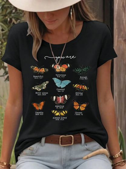 Woman wearing black t-shirt with colorful butterfly designs and positive Bible verse quotes