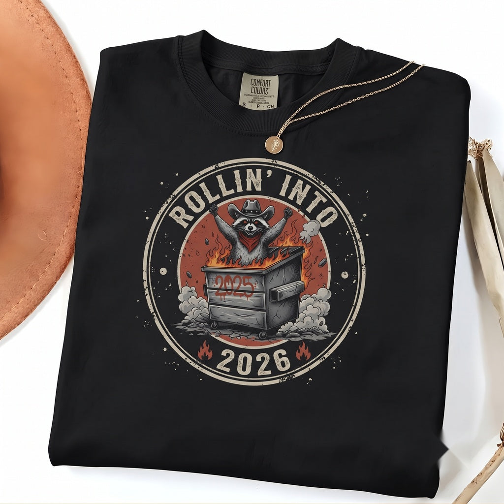 Rollin Into 2026 Funny Dumpster Fire Raccoon Chaotic New Year Humor Graphic Gift Unisex TShirt