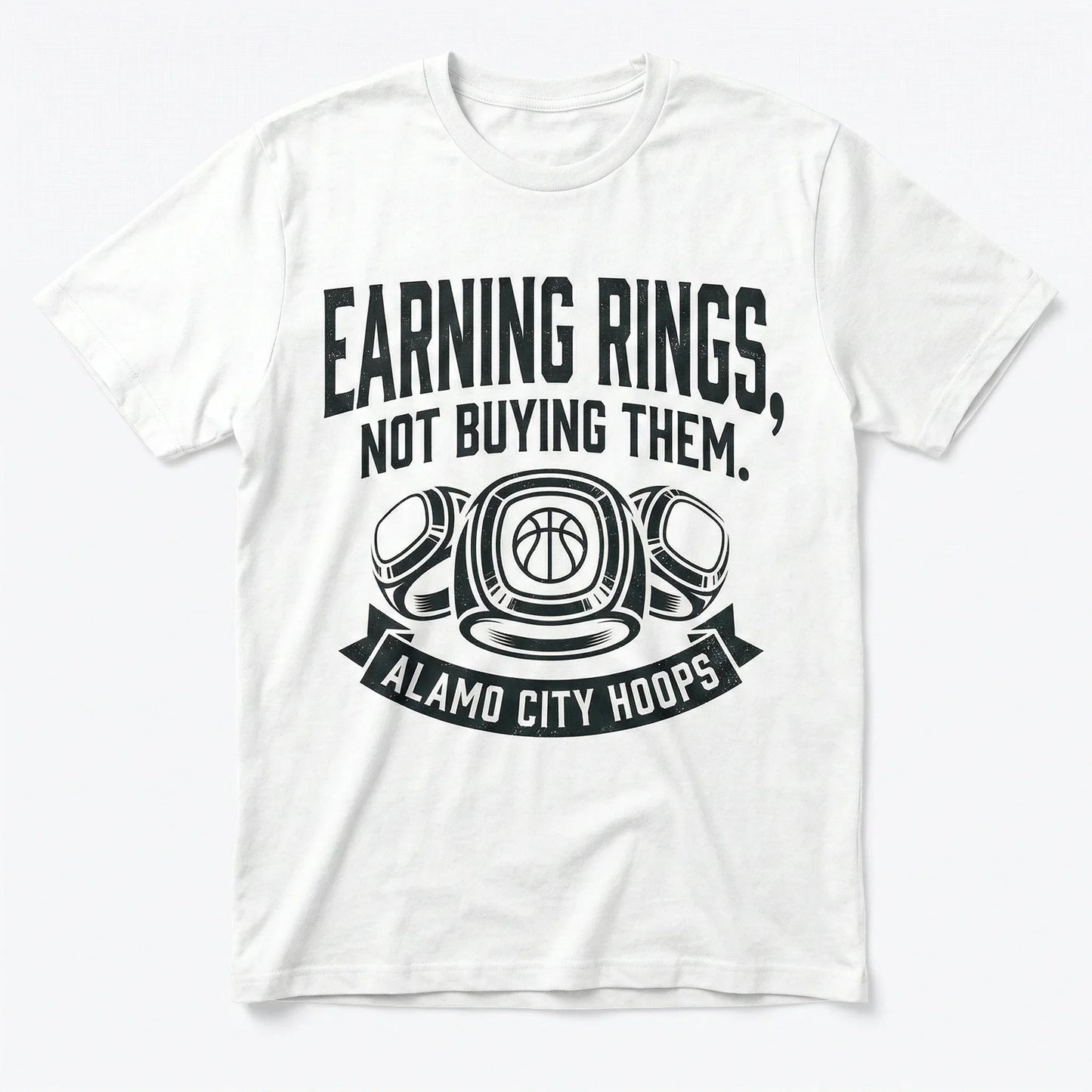 White t-shirt with 'Earning Rings, Not Buying Them. Alamo City Hoops' basketball graphic.