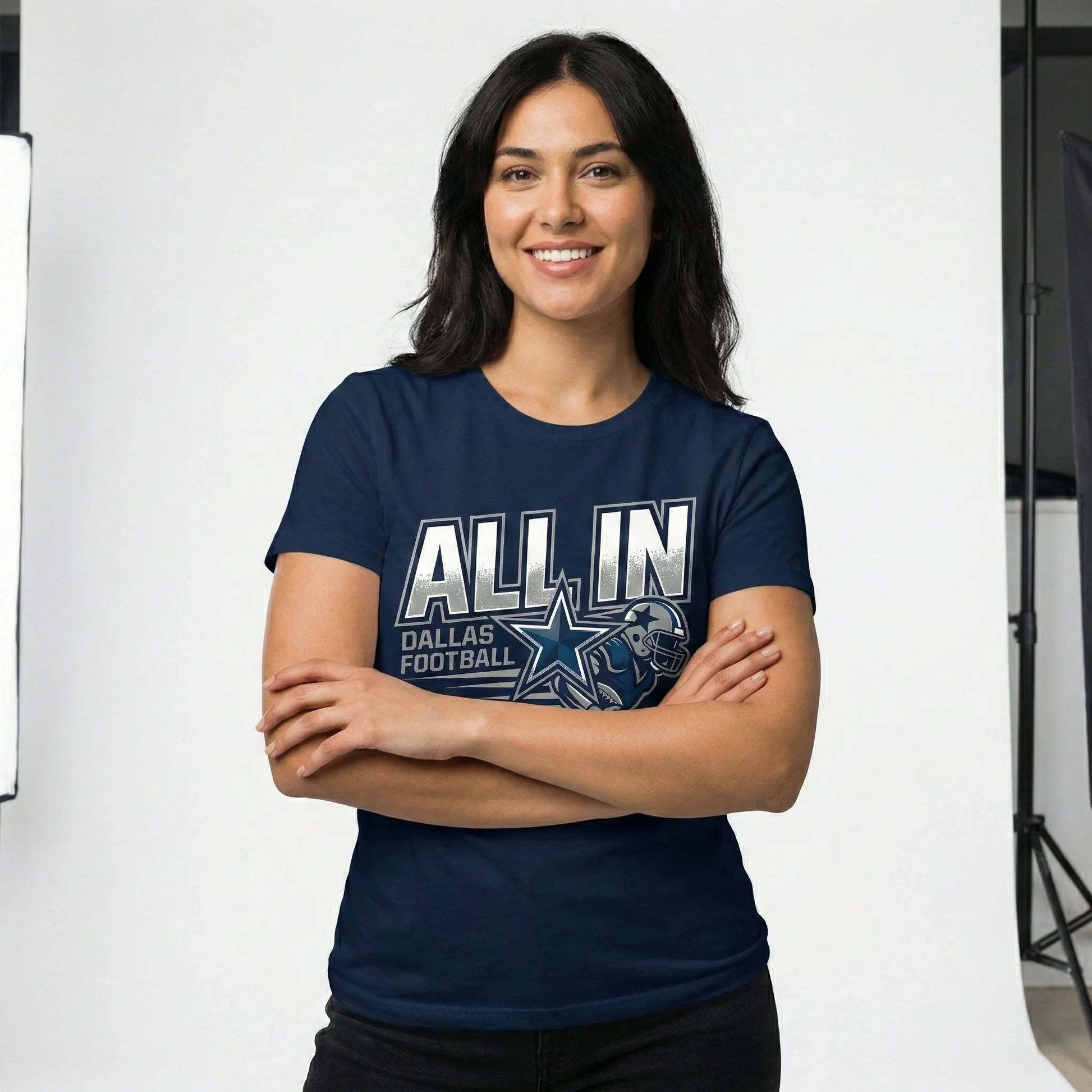 Smiling woman wearing navy blue 'ALL IN Dallas Football' T-shirt in studio setting