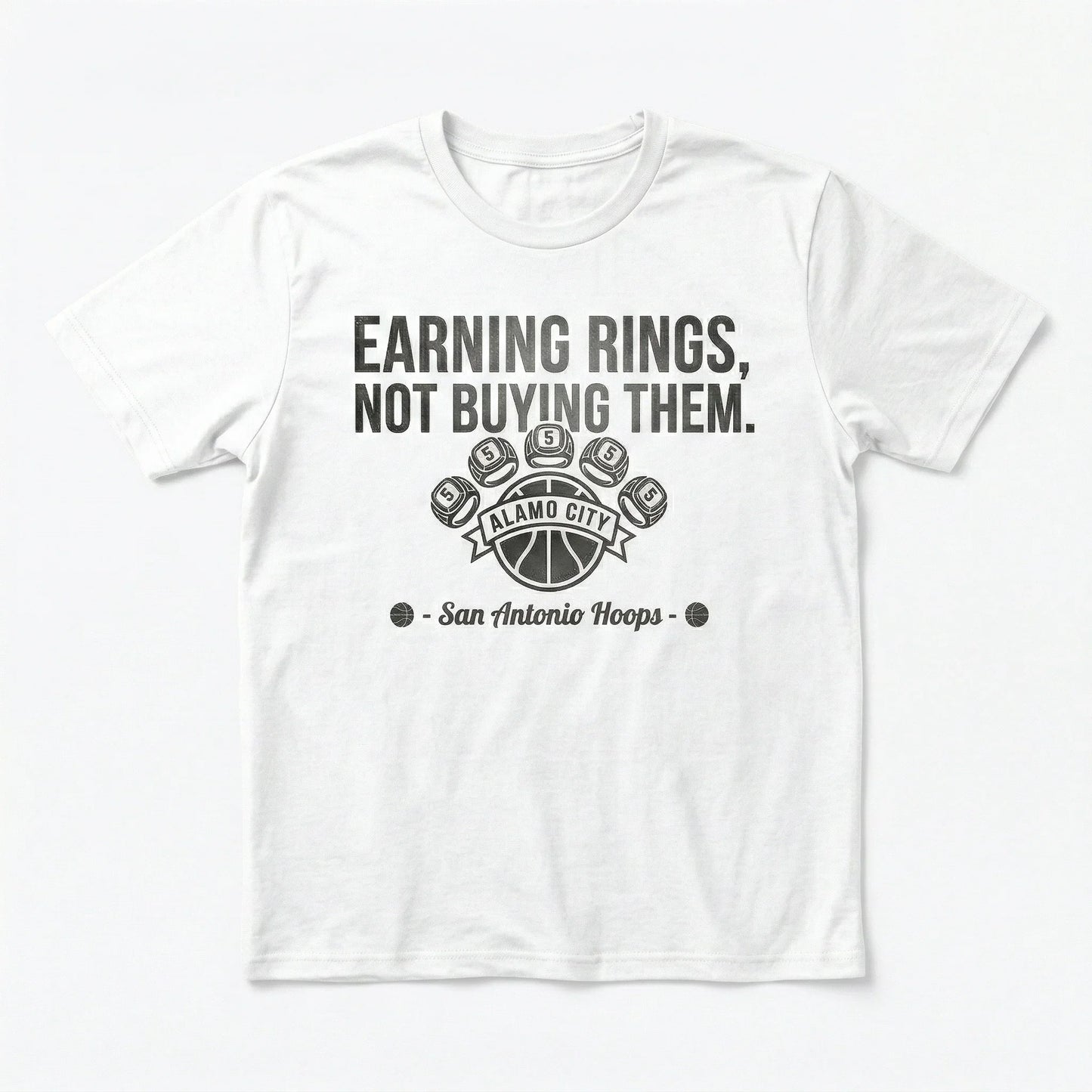 White t-shirt with "Earning Rings, Not Buying Them" basketball graphic and San Antonio Hoops text.