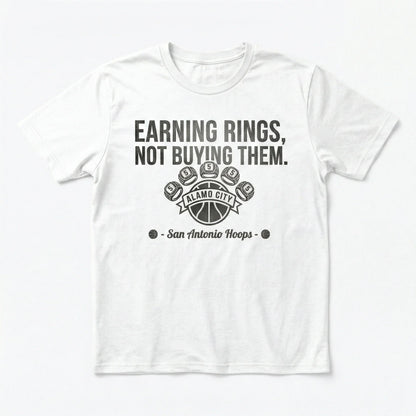White t-shirt with "Earning Rings, Not Buying Them" basketball graphic and San Antonio Hoops text.