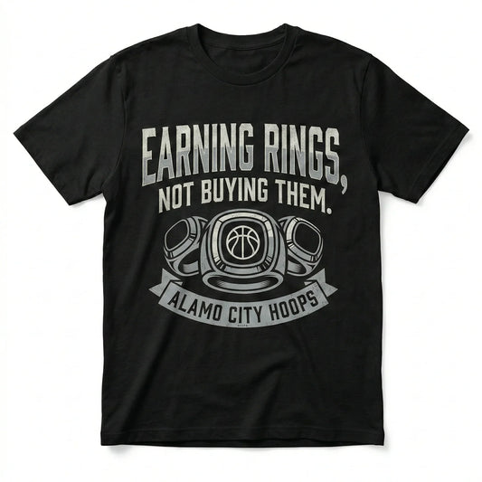Black t-shirt with 'Earning Rings, Not Buying Them. Alamo City Hoops' and basketball rings graphic