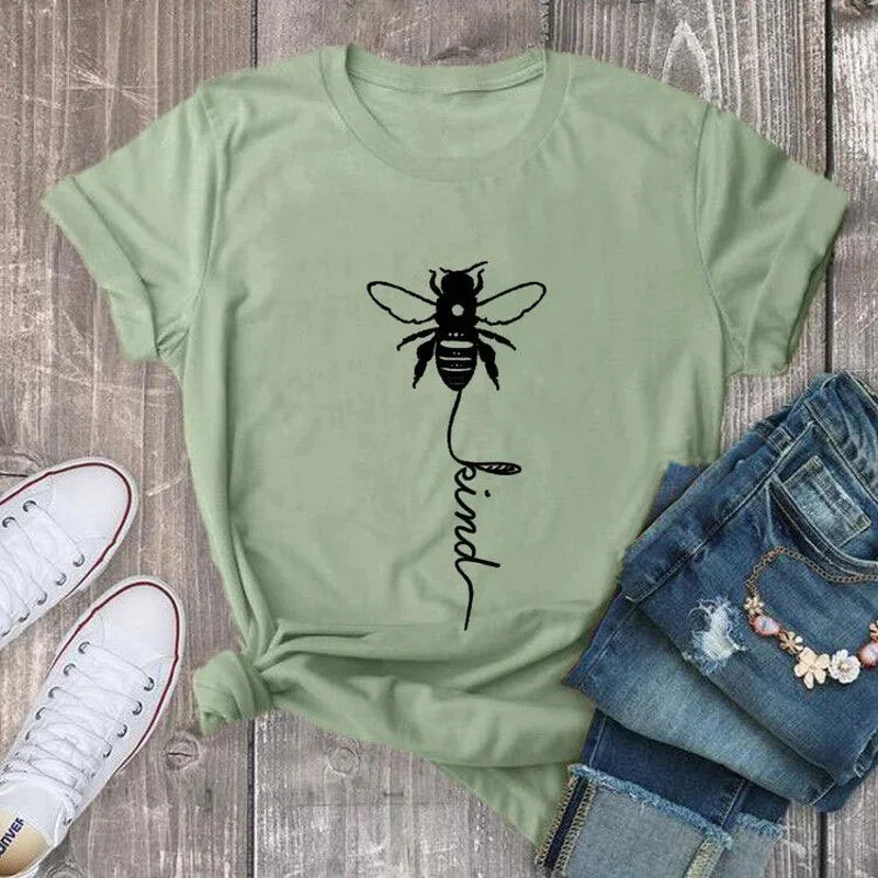 Light green t-shirt with black bee and 'kind' graphic, styled with jeans and sneakers