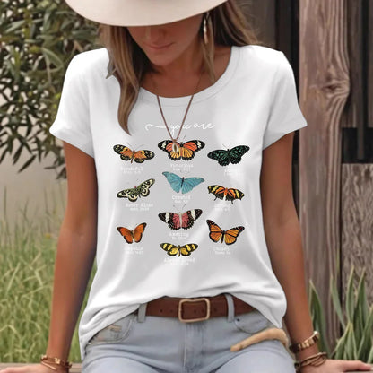 Woman outdoors wearing a white t-shirt with colorful butterflies and uplifting text.