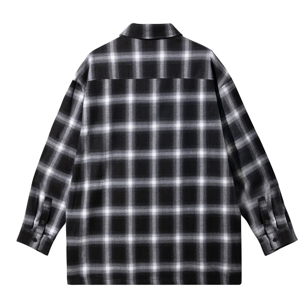 Black and white plaid flannel shirt with long sleeves, shown from the back.