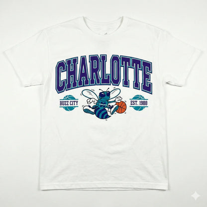 White t-shirt with large CHARLOTTE text, cartoon hornet, basketball, and Buzz City design