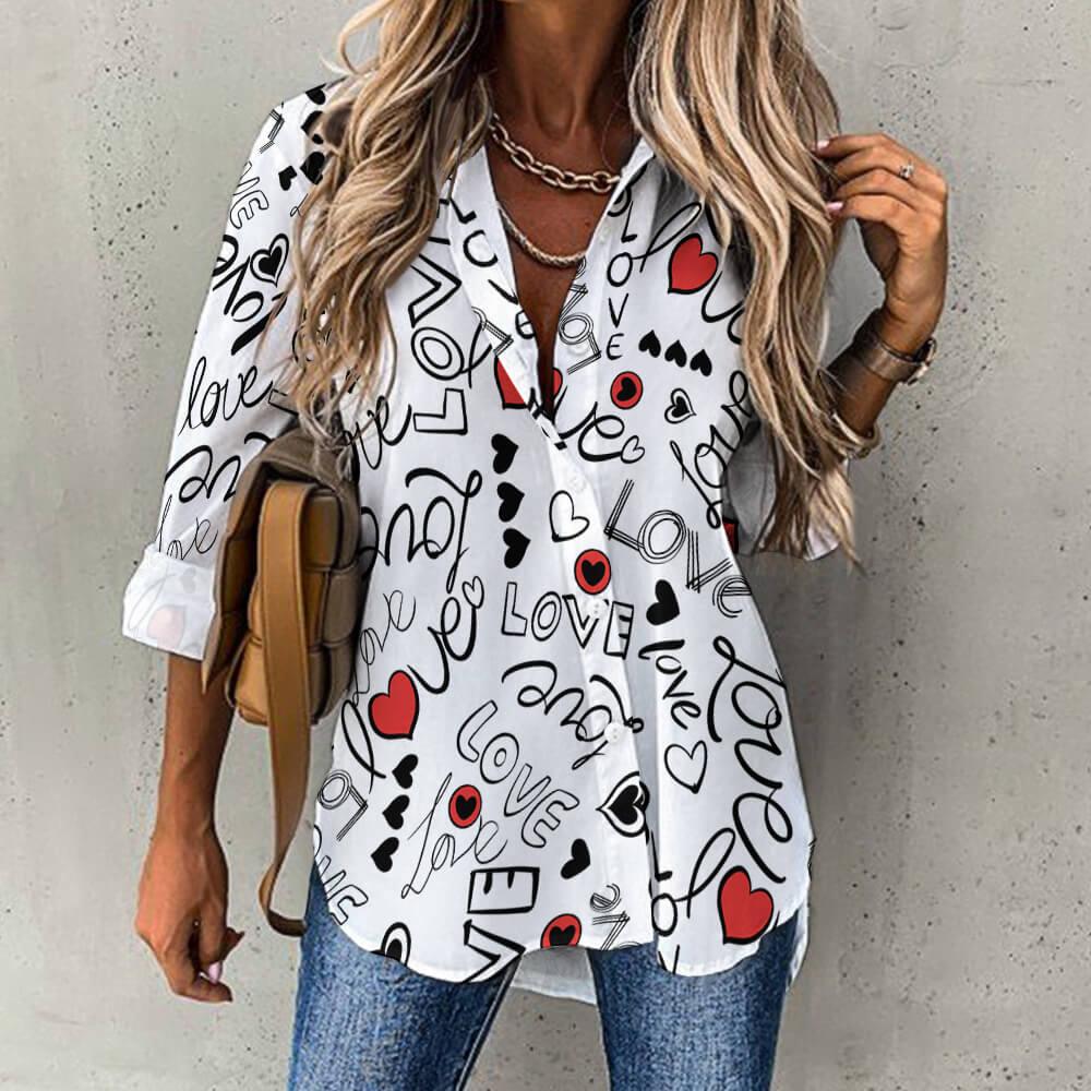 Woman wearing white button-up shirt with black 'love' letters, red hearts, and casual jeans